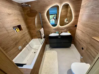 a bathroom with two sinks and a tub and mirrors at Casa Jean Baptiste in Lecci
