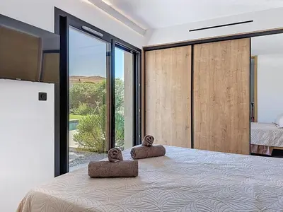 a bedroom with a large bed with two pillows on it at Casa Jean Baptiste in Lecci