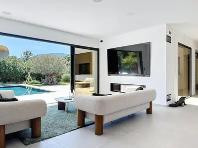 a living room with a tv and a pool at Casa Jean Baptiste in Lecci