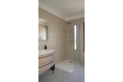 a bedroom with a bed and a large window at villa vue mer in Calcatoggio