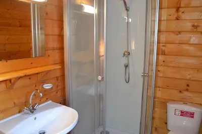 a bathroom with a shower and a sink and a toilet at camping la vallée in Coti-Chiavari