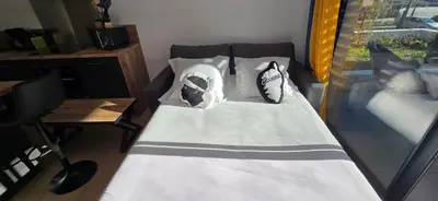 a bed with pillows on it in a room at Joli T2 cozy, proche plages, Terra Doru B02 in Propriano