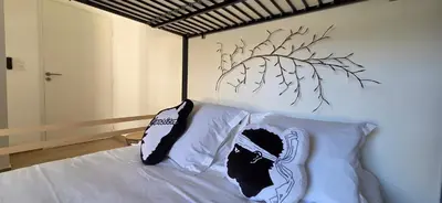 a bedroom with a bed with two pillows on it at Joli T2 cozy, proche plages, Terra Doru B02 in Propriano