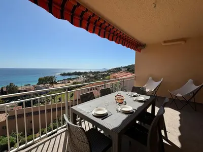 a table on a balcony with a view of the ocean at Studio K4 santa lina sanguinaires Ajaccio in Ajaccio