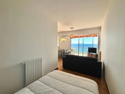 a bedroom with a bed and a view of the ocean at Studio K4 santa lina sanguinaires Ajaccio in Ajaccio