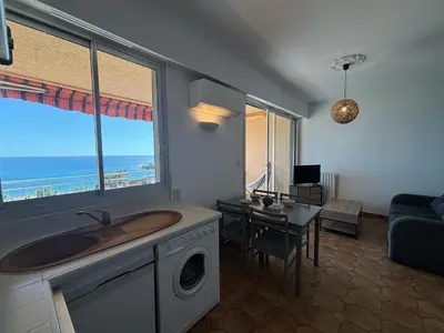 a living room with a sink and a washing machine at Studio K4 santa lina sanguinaires Ajaccio in Ajaccio