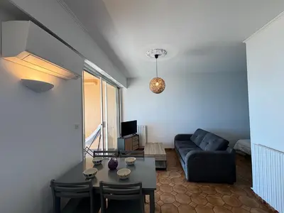 a living room with a couch and a table at Studio K4 santa lina sanguinaires Ajaccio in Ajaccio