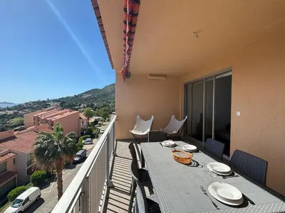a balcony with a table and chairs on a balcony at Studio K4 santa lina sanguinaires Ajaccio in Ajaccio