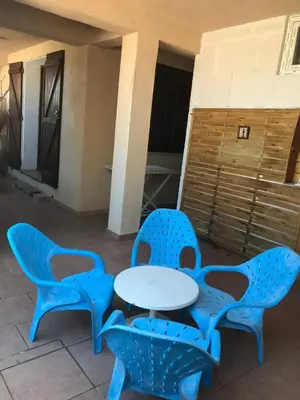 a table and two chairs on a patio at Appartement cosy à Propriano, 45 m², terrasse in Propriano