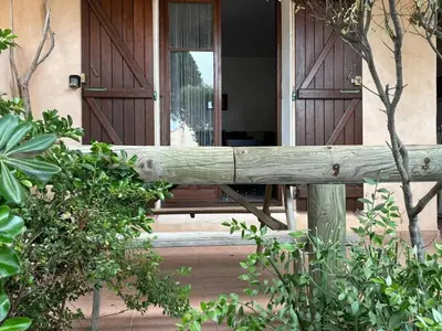 a wooden fence in front of a house at Appartement cosy à Propriano, 45 m², terrasse in Propriano