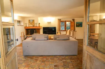 a living room with a couch and a flat screen tv at La bergerie de Sotta in Sotta