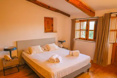 a bedroom with a bed with two towels on it at La bergerie de Sotta in Sotta