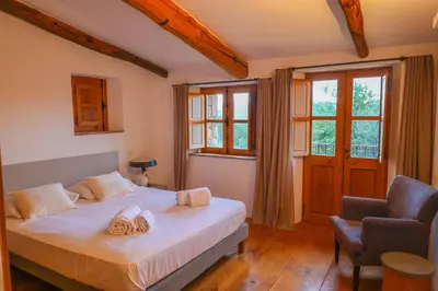 a bedroom with a bed with two towels on it at La bergerie de Sotta in Sotta