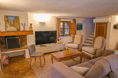 a living room with a couch and a tv at La bergerie de Sotta in Sotta