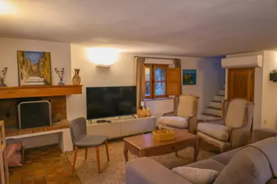 a living room with a couch and a tv at La bergerie de Sotta in Sotta