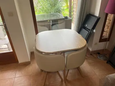 a table and chairs in a room with a window at Mini Villa Alba Rossa in Serra-di-Ferro