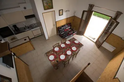 an overhead view of a kitchen with a table and chairs at Sarl Aurore-Vacances in Vico