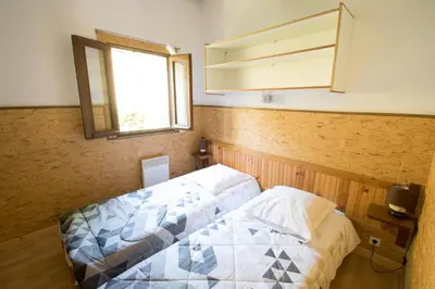 a bedroom with a bed and a mirror on the wall at Sarl Aurore-Vacances in Vico