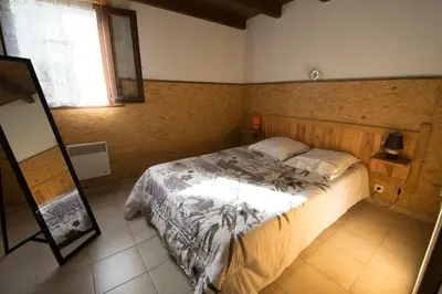 a bedroom with a bed and a mirror at Sarl Aurore-Vacances in Vico