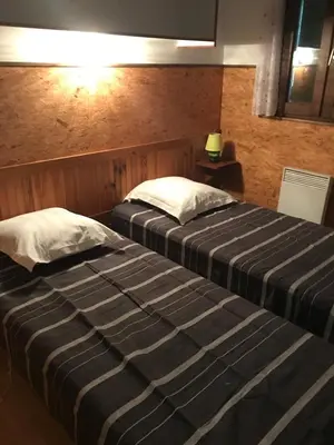 two beds in a hotel room with at Sarl Aurore-Vacances in Vico