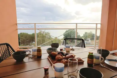 a table with a bowl of food on top of it at Les Sanguinaires N31 - T2 Vue Mer, Piscine, Plage in Ajaccio