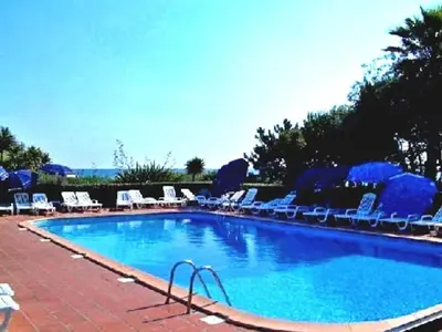 a large swimming pool with lounge chairs at Marines de Moriani in Moriani Plage