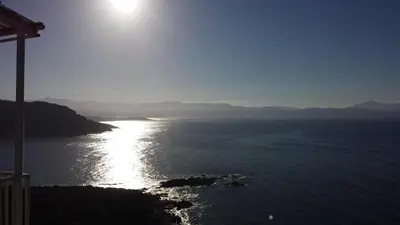 a view of a body of water with the sun at Bel Mare in Cargèse