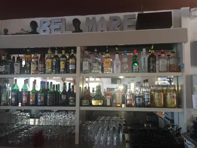 a bar with a lot of bottles of alcohol at Bel Mare in Cargèse