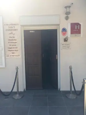 a door in a building with ropes in front of it at Bel Mare in Cargèse