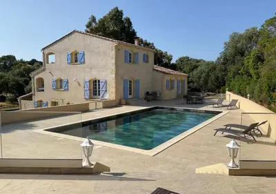 a house with a swimming pool in front of a house at Villa Vitalba - Le charme corse avec piscine in Sartène