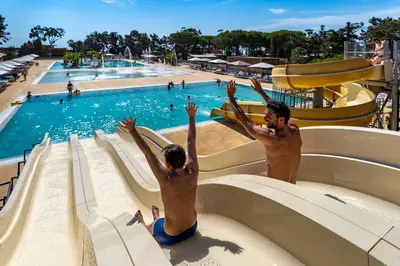 two people on a water slide at a water park at Villa avec piscine privée in Venzolasca