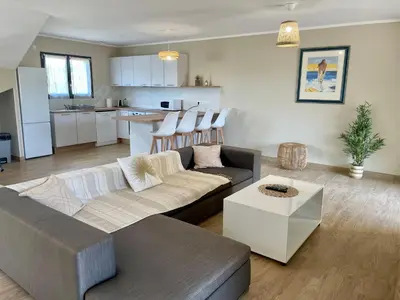 a living room with a couch and a table at Villa avec piscine privée in Venzolasca