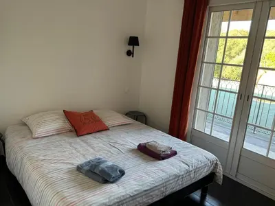 a bedroom with a bed with two towels on it at Villa Ratino in Bonifacio