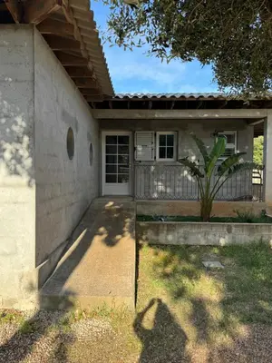 a small house with a door and a yard at Villa Ratino in Bonifacio