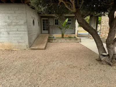 a house with a tree in front of it at Villa Ratino in Bonifacio