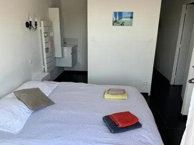 a bedroom with a white bed with two towels on it at Villa Ratino in Bonifacio