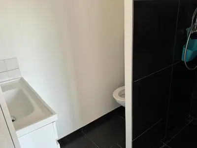 a bathroom with a white toilet and a sink at Villa Ratino in Bonifacio