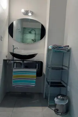a bathroom with a sink and a mirror at Villa 300m2 piscine chauffée et jacuzzi-spa de nage in Afa