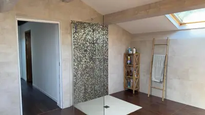 a bathroom with a shower with a glass door at Villa 300m2 piscine chauffée et jacuzzi-spa de nage in Afa