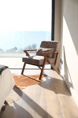 a chair sitting in a room with a large window at Villa Rétine in Ajaccio