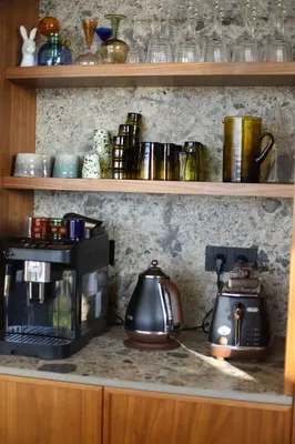 a kitchen counter with a coffee maker and a tea kettle at Villa Rétine in Ajaccio