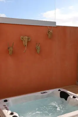 a jacuzzi tub with four heads on a wall at Villa Rétine in Ajaccio