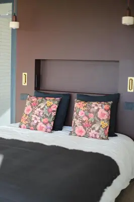 a bedroom with a bed with two pillows on it at Villa Rétine in Ajaccio