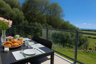 a table with a basket of bread on a balcony at A Macchia - T2 nature & couché de soleil in Figari