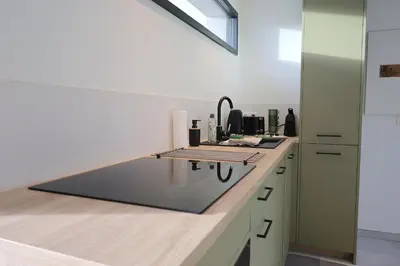 a kitchen with a counter top with a sink at A Macchia - T2 nature & couché de soleil in Figari