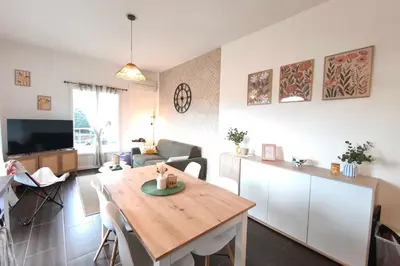 a living room with a wooden table and a living room at Bright apartment in Albitreccia near beach in Albitreccia