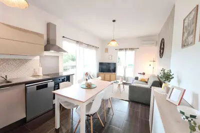 a kitchen and living room with a table in a kitchen at Bright apartment in Albitreccia near beach in Albitreccia