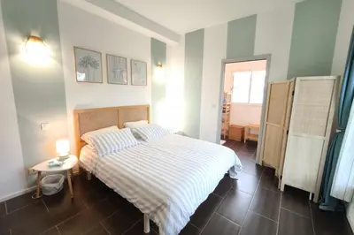 a bedroom with a bed and a table and a window at Bright apartment in Albitreccia near beach in Albitreccia