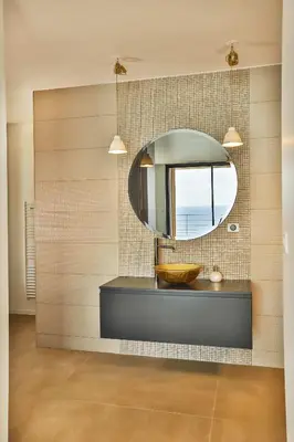 a bathroom with a sink and a mirror at Villa petra mare in Cargèse