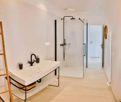 a bathroom with a sink and a shower at Villa petra mare in Cargèse